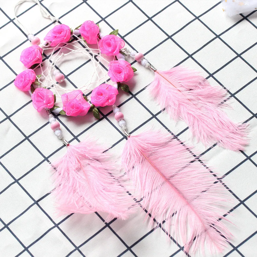 Close-up of a modern pink ostrich feather dreamcatcher wind chime wall ornament.