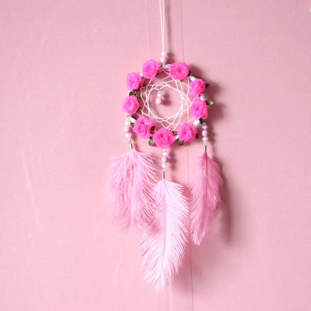 Close-up of a modern pink ostrich feather dreamcatcher wind chime wall ornament.