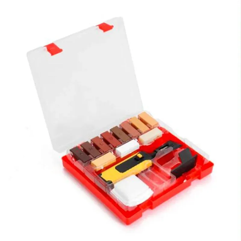 DIY floor and furniture repair kit with red handle and coloured wax sticks on a tile surface.