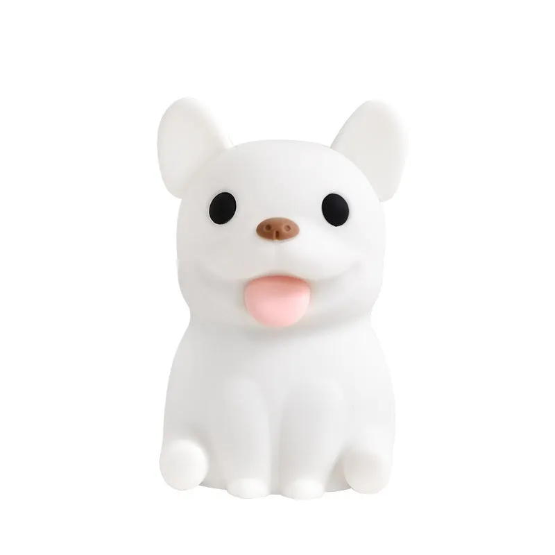 Silicone animal cartoon USB night light with Zodiac design on a bedside table.