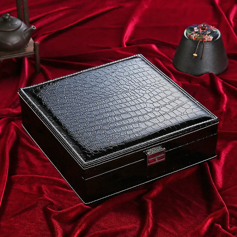 Green crocodile pattern leather double layer wooden jewellery box with lock open, showing storage compartments.