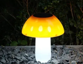 Solar garden mushroom light with ground spike for lawn and pathway illumination.