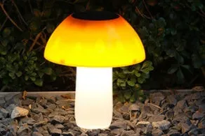 Solar garden mushroom light with ground spike for lawn and pathway illumination.