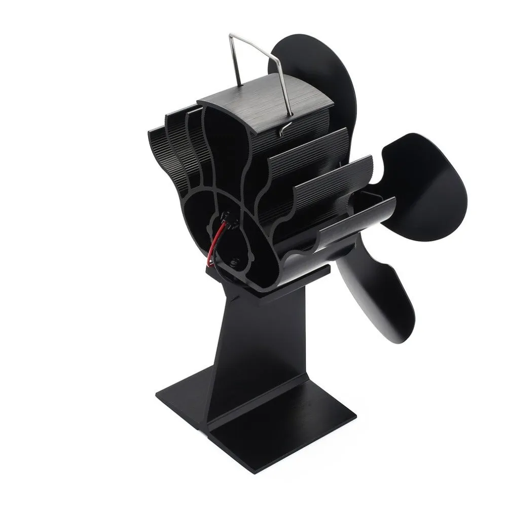 Black Yotsuba style thermodynamic fireplace fan on a hearth.