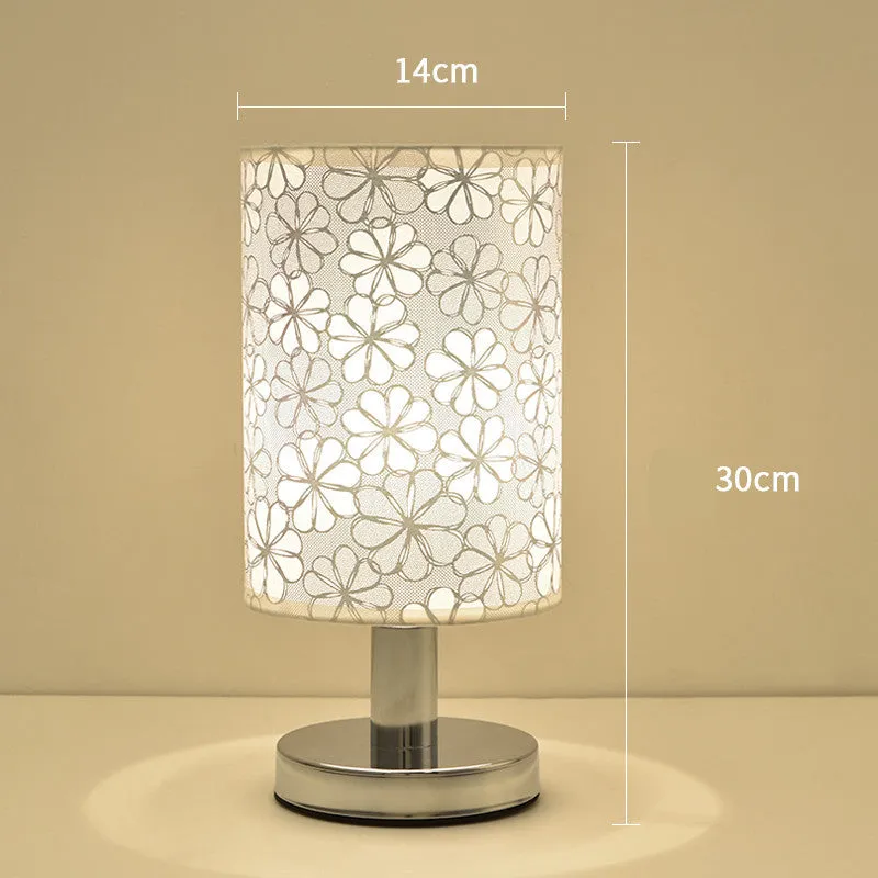 Small dimmable night light with cloth shade and iron base, showing remote control.