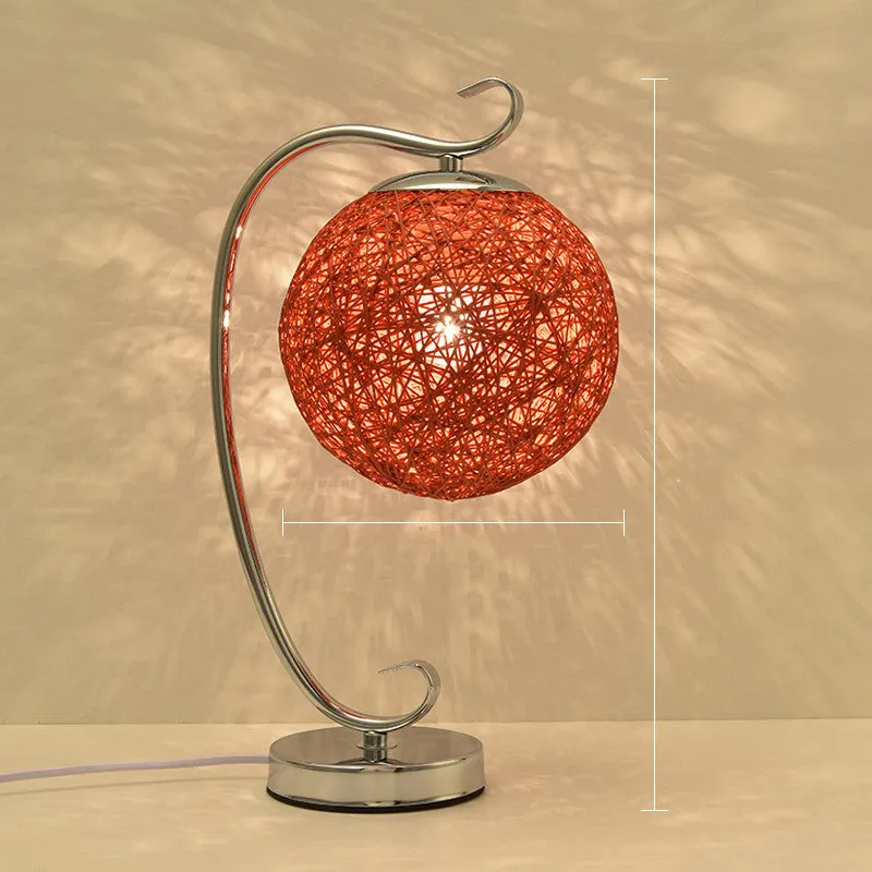 Small dimmable night light with cloth shade and iron base, showing remote control.