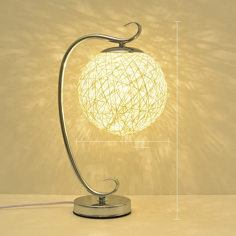 Small dimmable night light with cloth shade and iron base, showing remote control.
