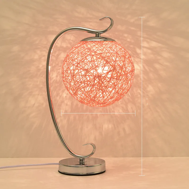 Small dimmable night light with cloth shade and iron base, showing remote control.