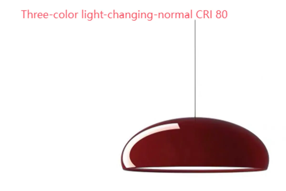 Danish iron pendant lamp in orange with adjustable cable hanging over a restaurant table.