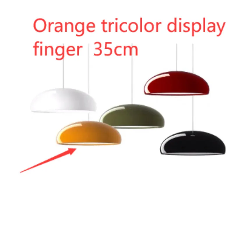 Danish iron pendant lamp in orange with adjustable cable hanging over a restaurant table.