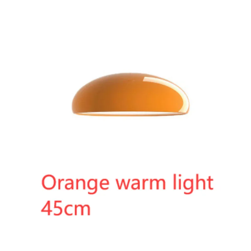Danish iron pendant lamp in orange with adjustable cable hanging over a restaurant table.