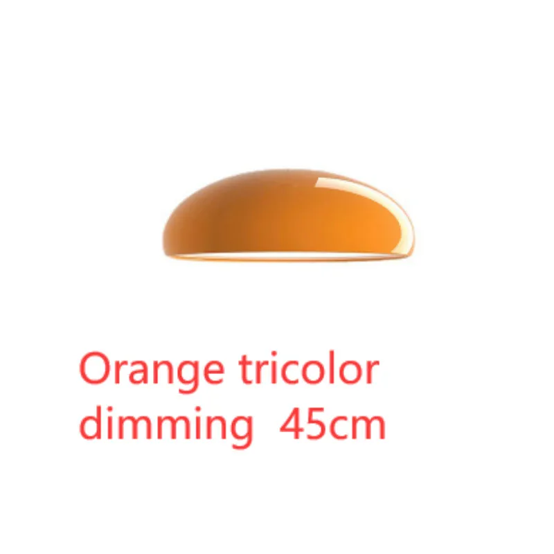 Danish iron pendant lamp in orange with adjustable cable hanging over a restaurant table.