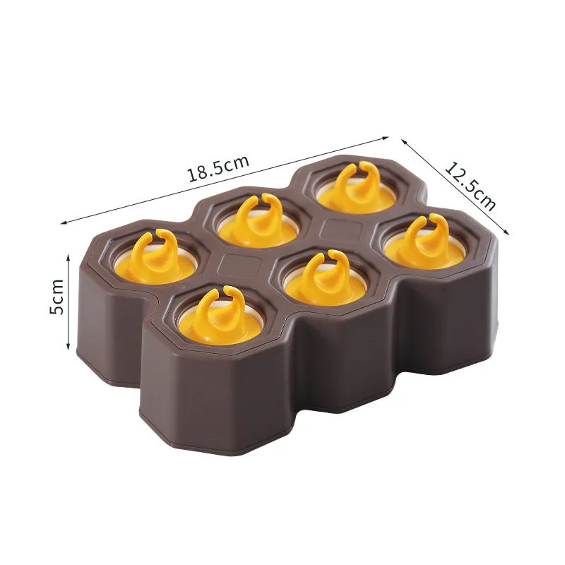Brown plastic ice cube mold with honeycomb design and anti-drip edges