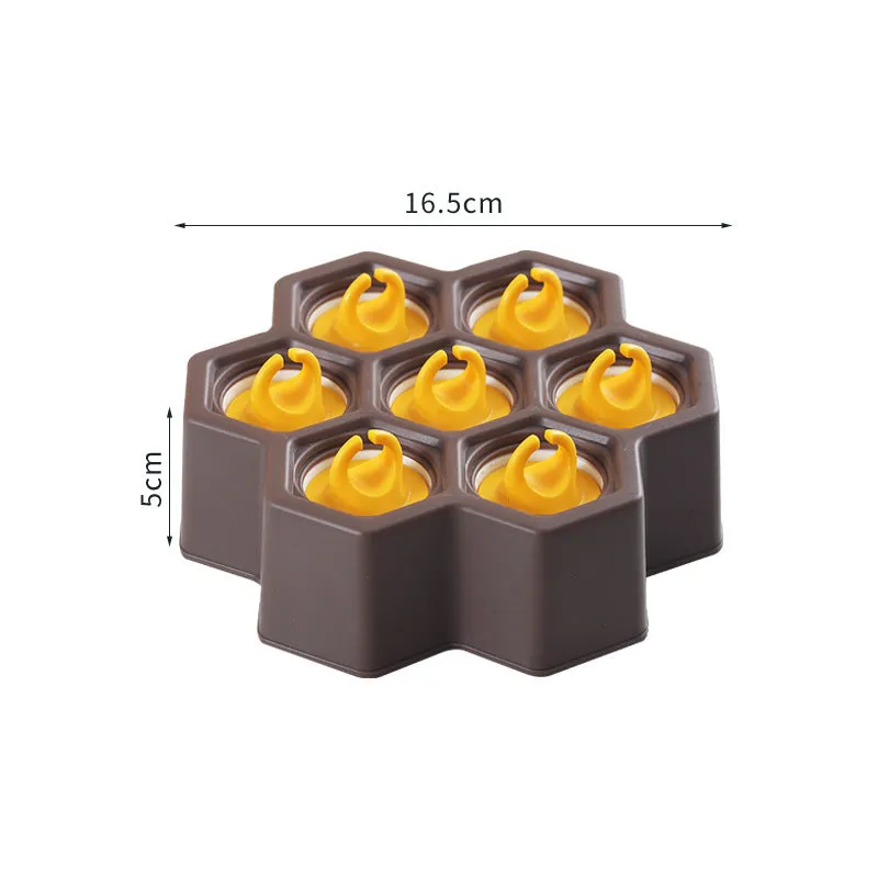 Brown plastic ice cube mold with honeycomb design and anti-drip edges