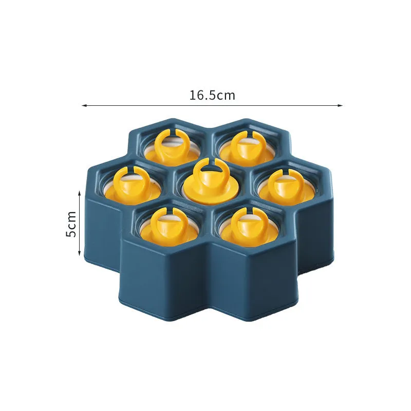 Brown plastic ice cube mold with honeycomb design and anti-drip edges
