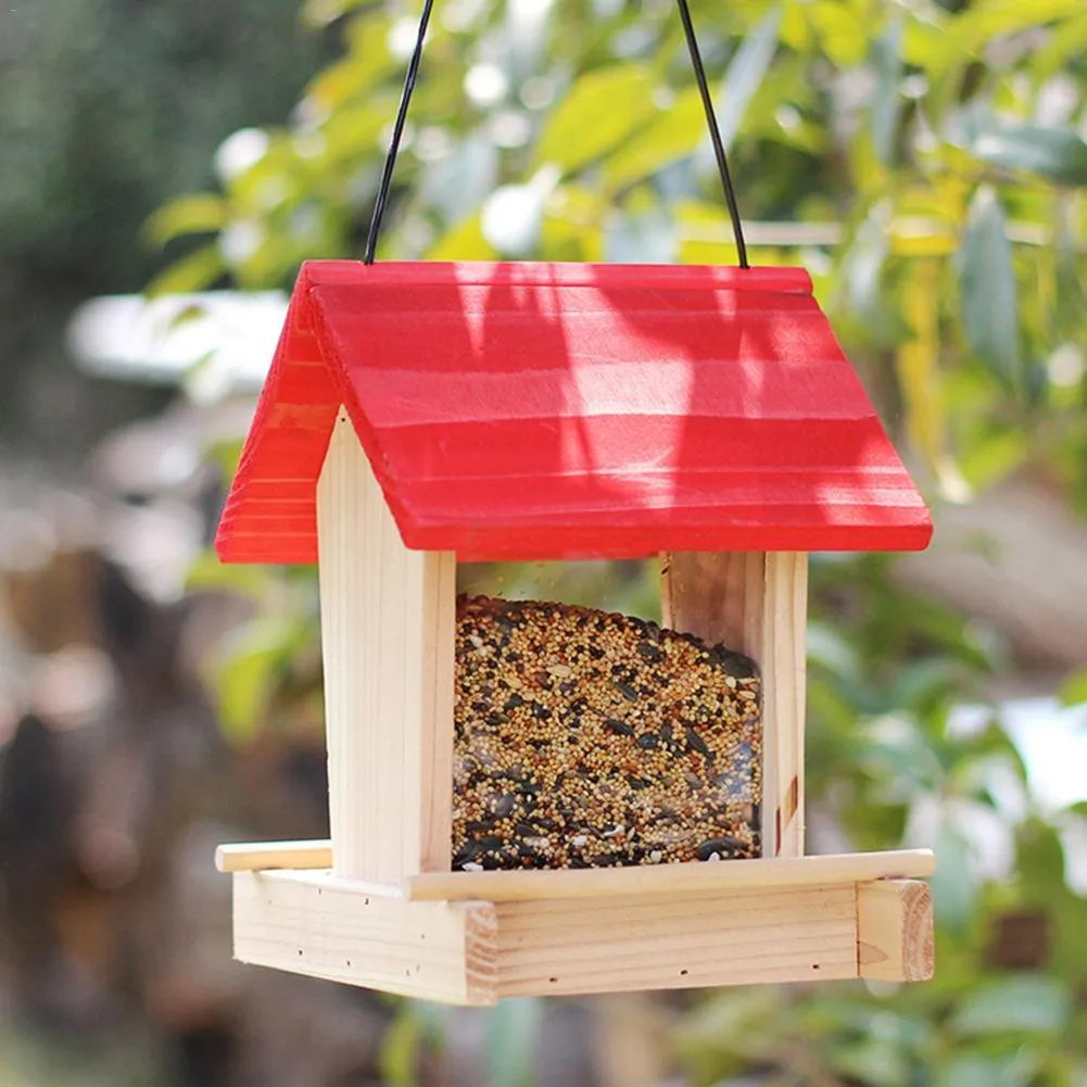 Suspended pine wood bird feeder with a red roof and log texture.