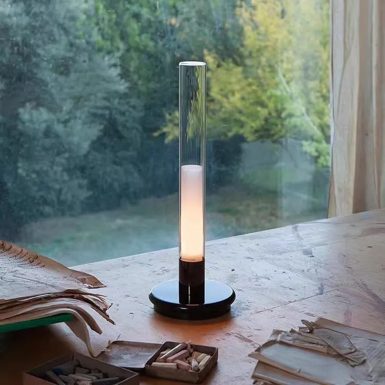 Black Nordic style candlelight table lamp showing three-colour LED light settings on a wooden desk.