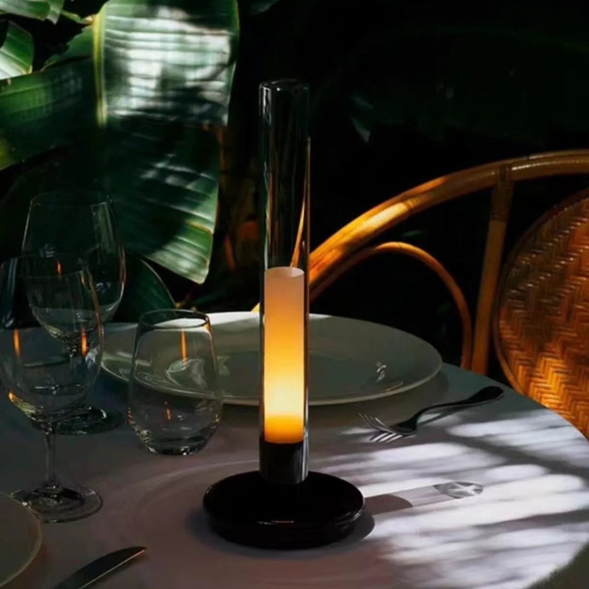 Black Nordic style candlelight table lamp showing three-colour LED light settings on a wooden desk.
