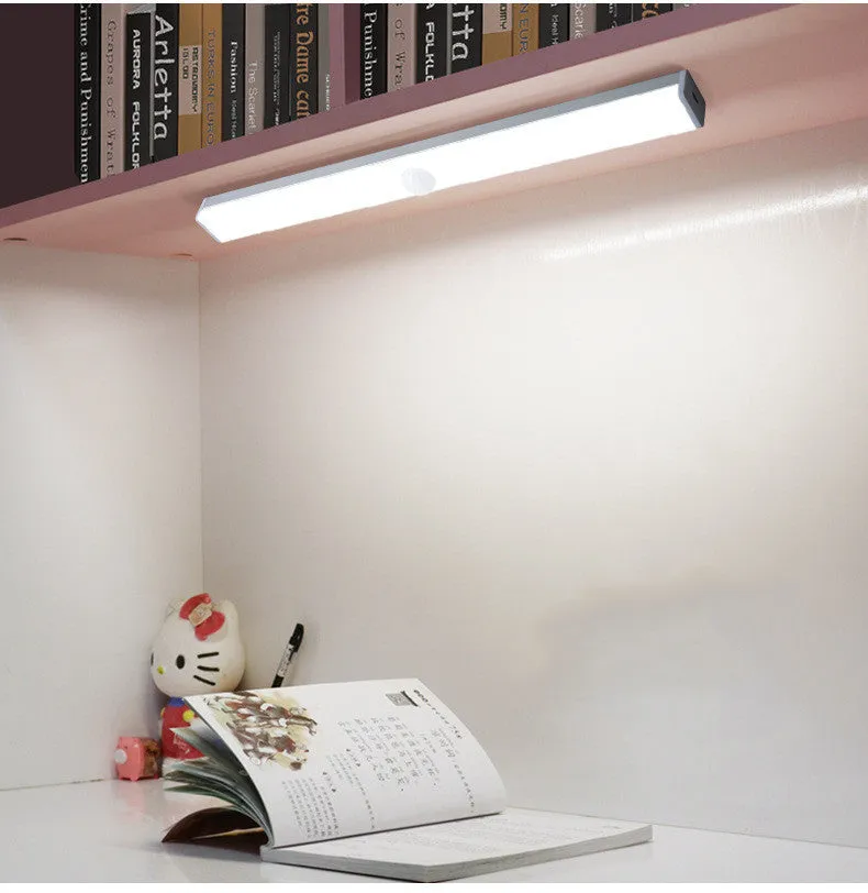 Black battery-powered LED strip light with motion sensor for cabinet or staircase installation.