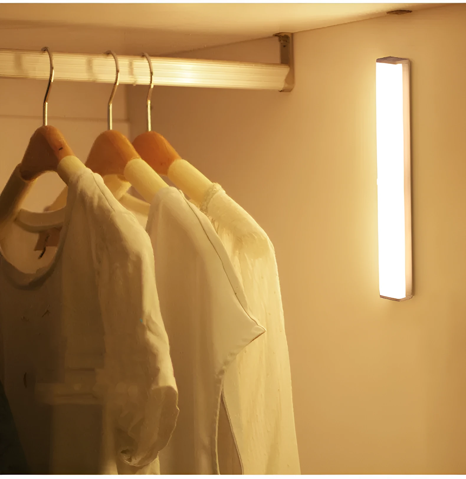 Black battery-powered LED strip light with motion sensor for cabinet or staircase installation.
