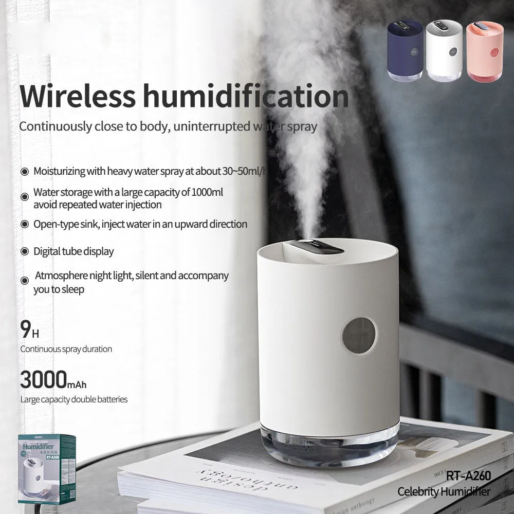 Blue wireless USB humidifier with water tank on a wooden desk next to a plant.