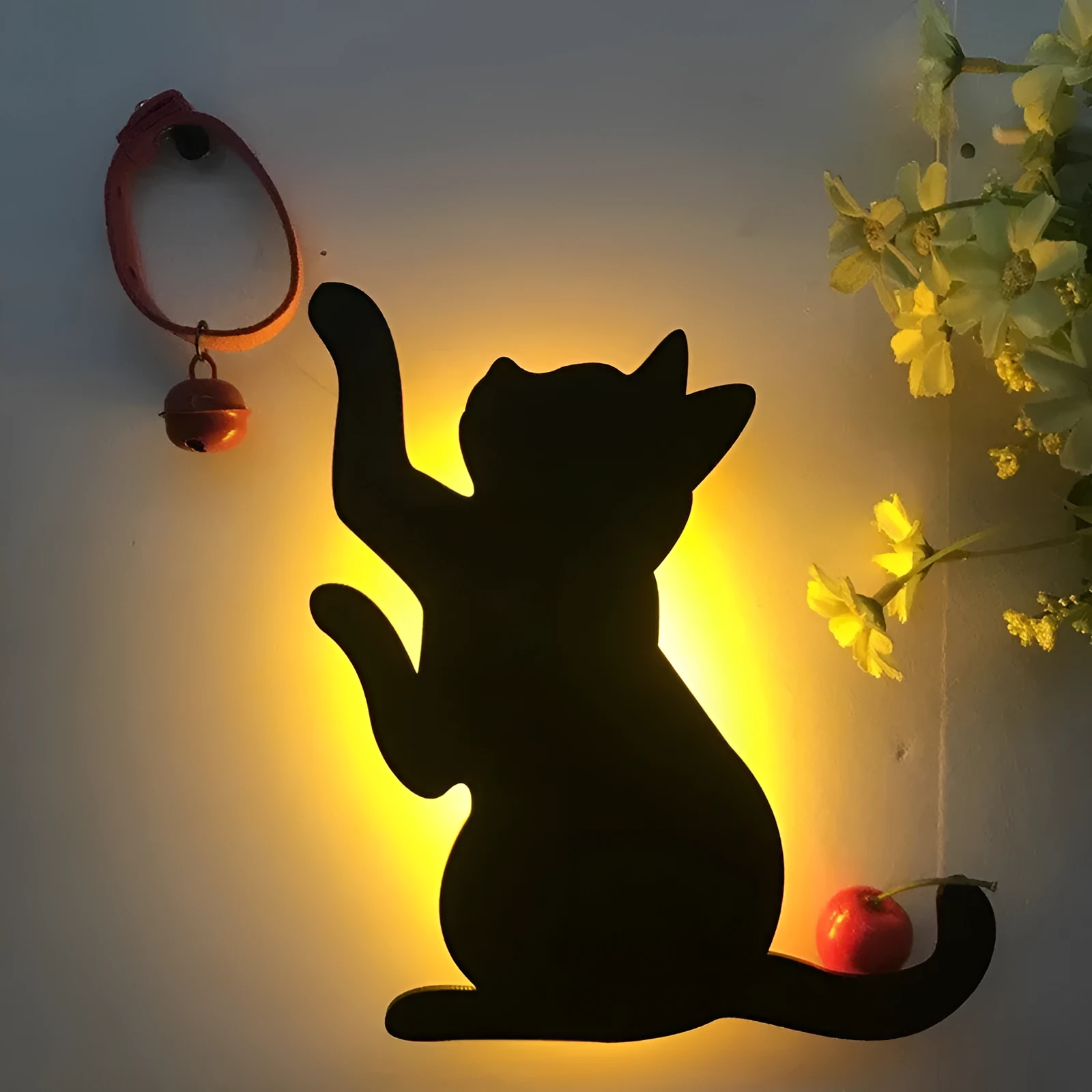 Black cartoon cat shaped LED night light with sound sensor for wall mounting.