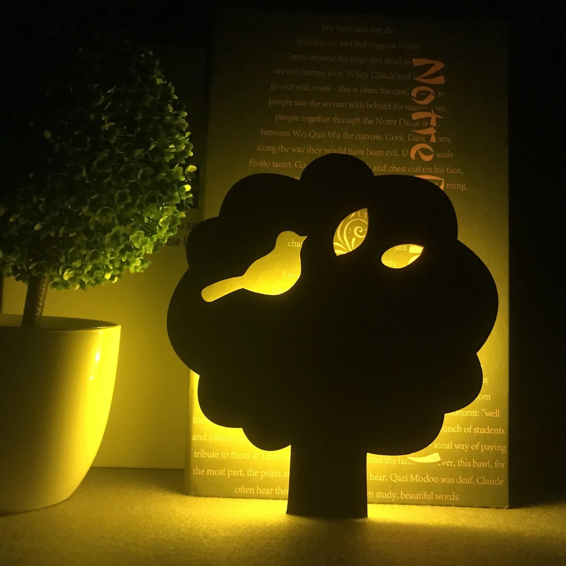 Black cartoon cat shaped LED night light with sound sensor for wall mounting.