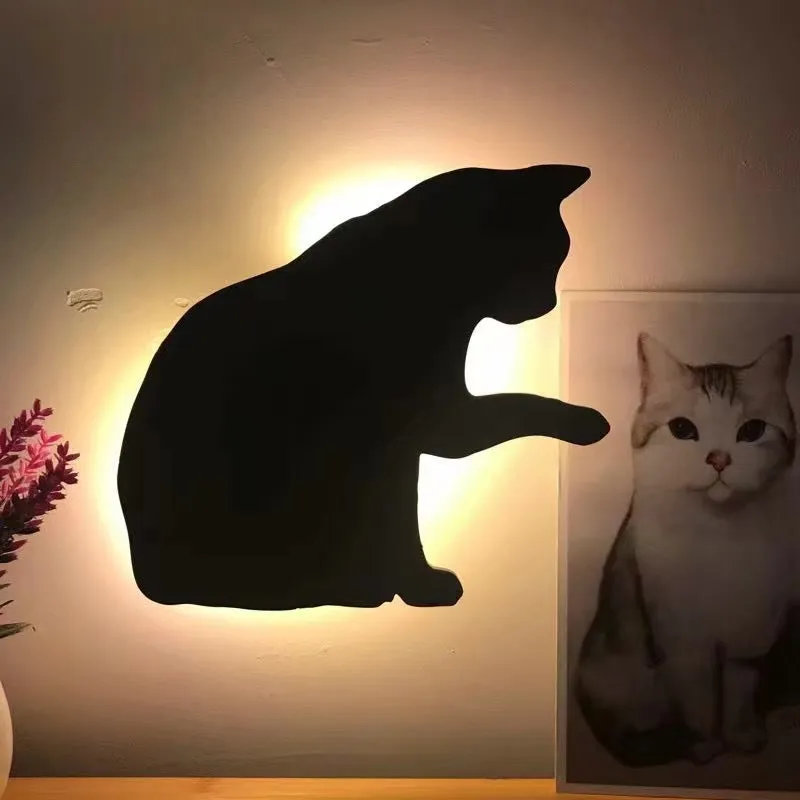 Black cartoon cat shaped LED night light with sound sensor for wall mounting.