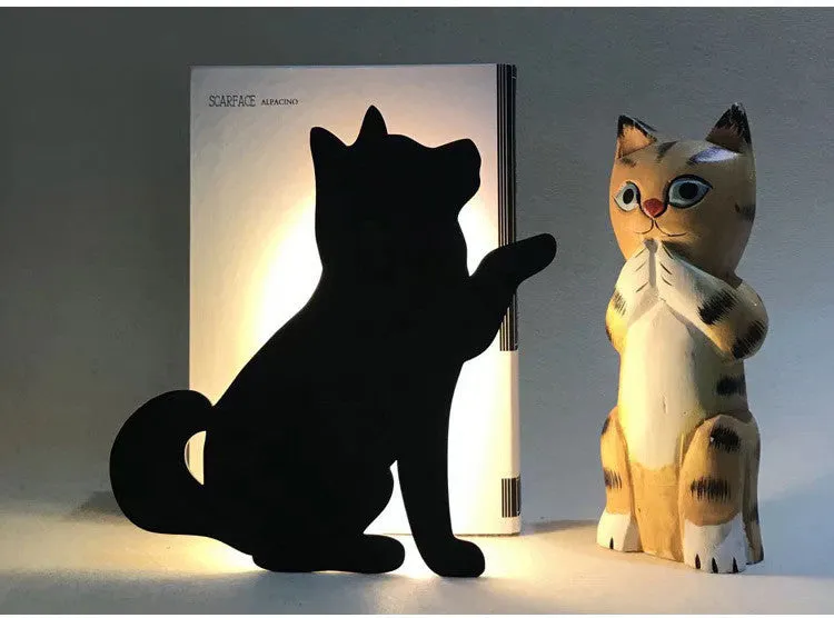 Black cartoon cat shaped LED night light with sound sensor for wall mounting.