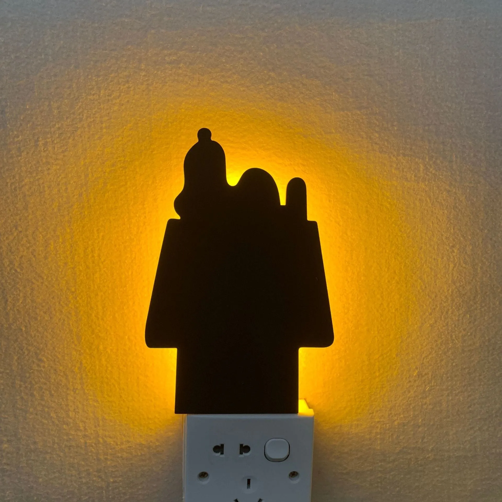 Black cartoon cat shaped LED night light with sound sensor for wall mounting.