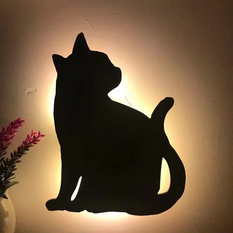 Black cartoon cat shaped LED night light with sound sensor for wall mounting.