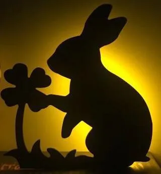 Black cartoon cat shaped LED night light with sound sensor for wall mounting.