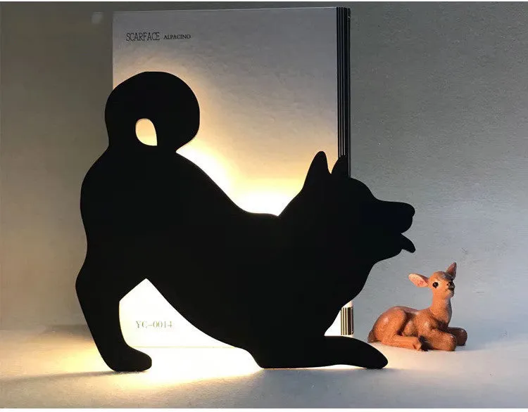 Black cartoon cat shaped LED night light with sound sensor for wall mounting.