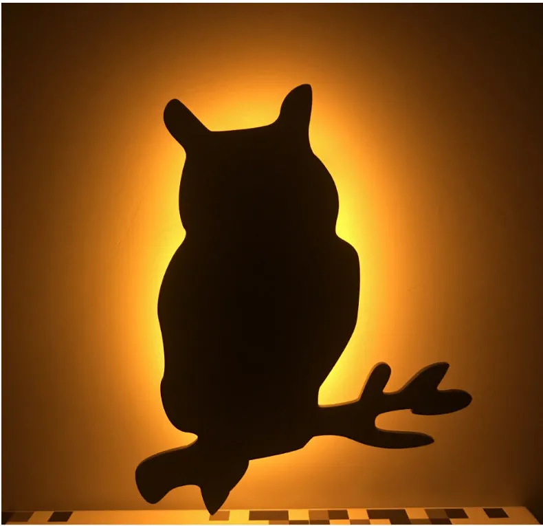 Black cartoon cat shaped LED night light with sound sensor for wall mounting.
