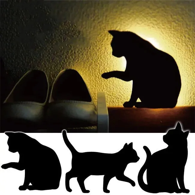 Black cartoon cat shaped LED night light with sound sensor for wall mounting.