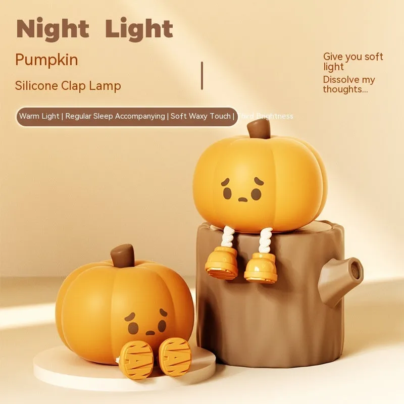 Orange silicone pumpkin night light with USB charging port and cotton accents, displayed as decorative lantern