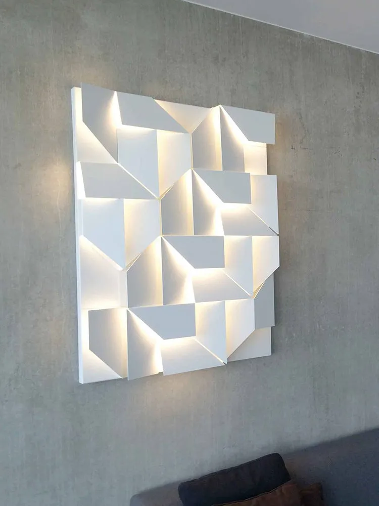 Minimalist rectangular wall lamp in matte white finish, shown in a living room setting.