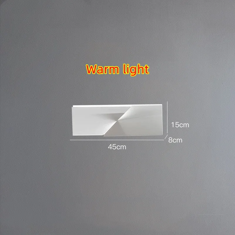 Minimalist rectangular wall lamp in matte white finish, shown in a living room setting.
