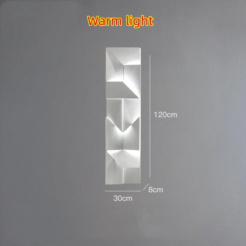 Minimalist rectangular wall lamp in matte white finish, shown in a living room setting.