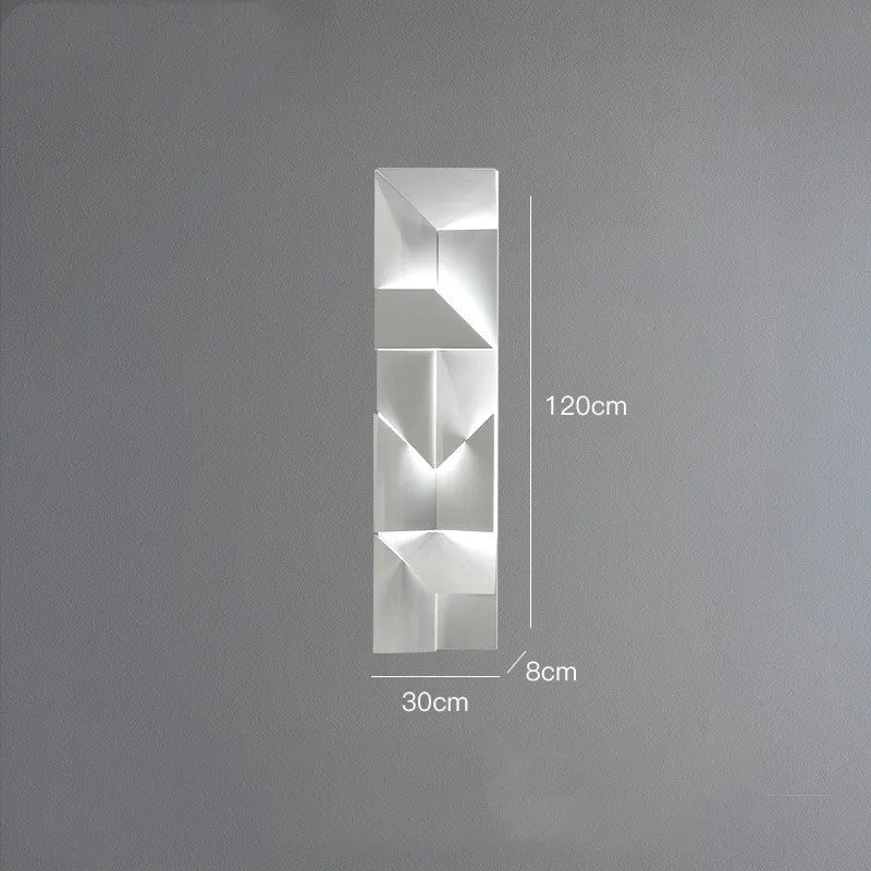 Minimalist rectangular wall lamp in matte white finish, shown in a living room setting.