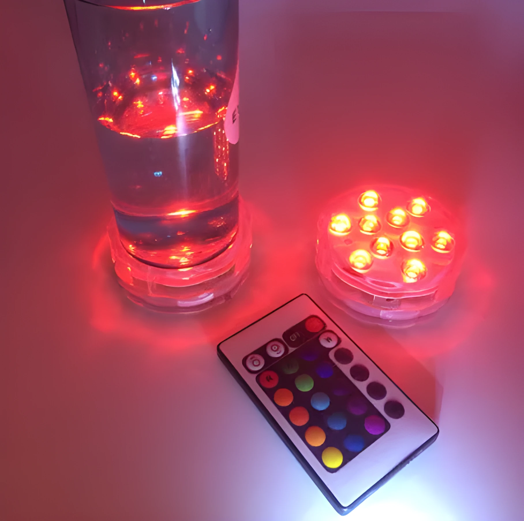 Round white battery-operated LED candle lamp suitable for submersible decoration.