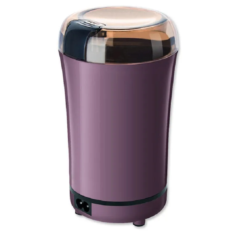 Black or purple mini electric grinder with stainless steel liner on a kitchen worktop