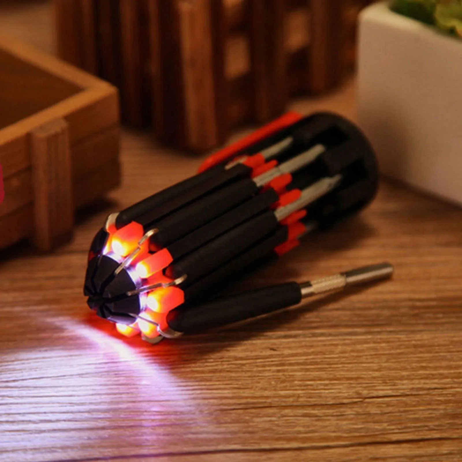 8-in-1 screwdriver with LED flashlight, magnetic bits, and stainless steel body on a workbench