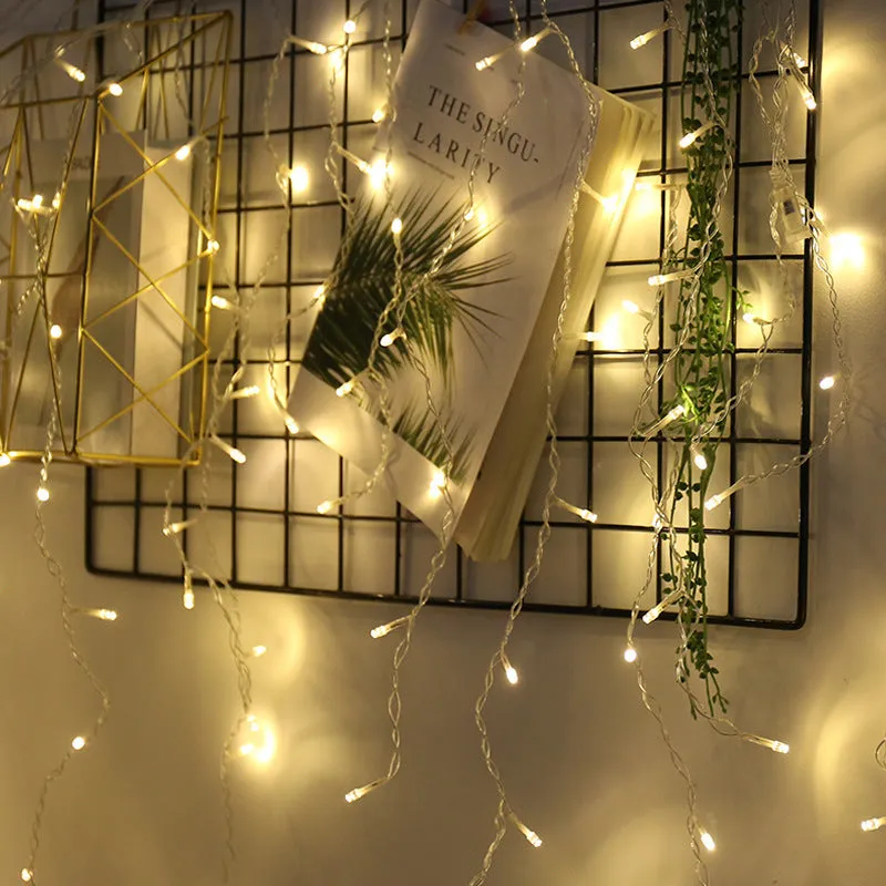 LED starry icicle light string with 96 lights on a 4-metre wire, showing three lengths of icicle drops in warm white illumination