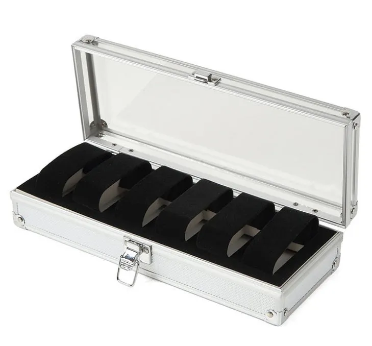 Brushed aluminium watch box holding six watches with a front jewellery storage bin.