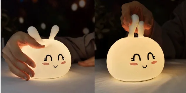 White marshmallow bunny LED night light with shy face or happy face option on a table.