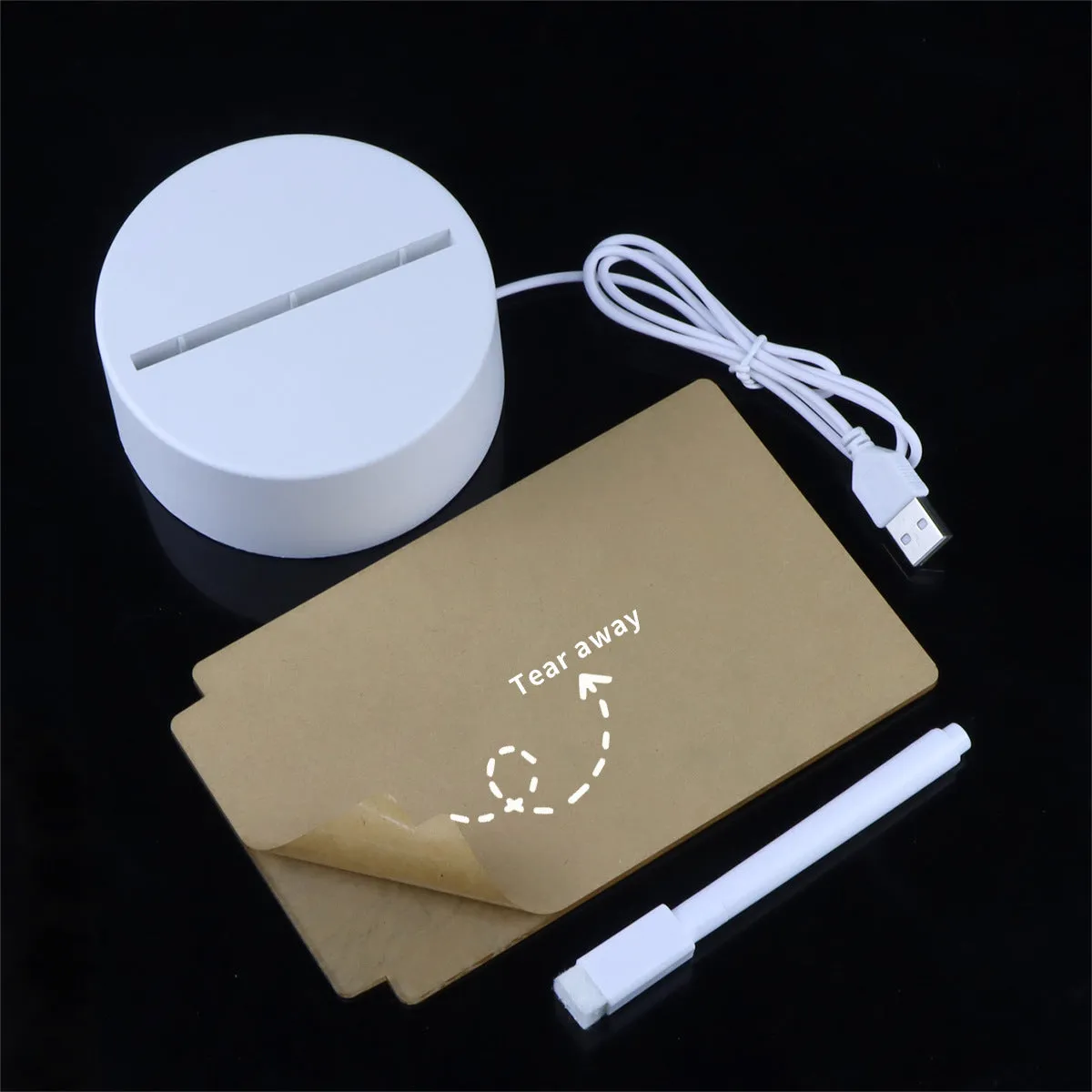 Heart-shaped LED light note board with warm yellow USB light and drawing pen on a desk