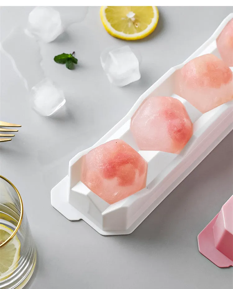 Flexible silicone ice tray showing large ice hockey, pentagon, and spherical mould designs in light blue.