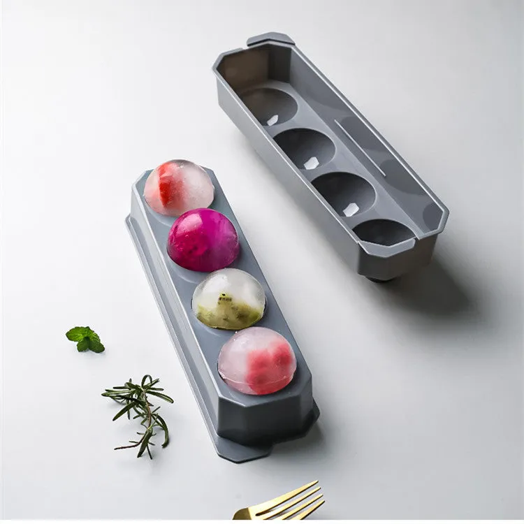 Flexible silicone ice tray showing large ice hockey, pentagon, and spherical mould designs in light blue.