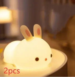 Rabbit silicone pat night light with seven-colour LED on a study desk
